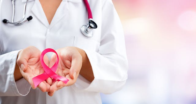 doctor with breast cancer ribbon | Image credit: Romolo Tavani - stock.adobe.com